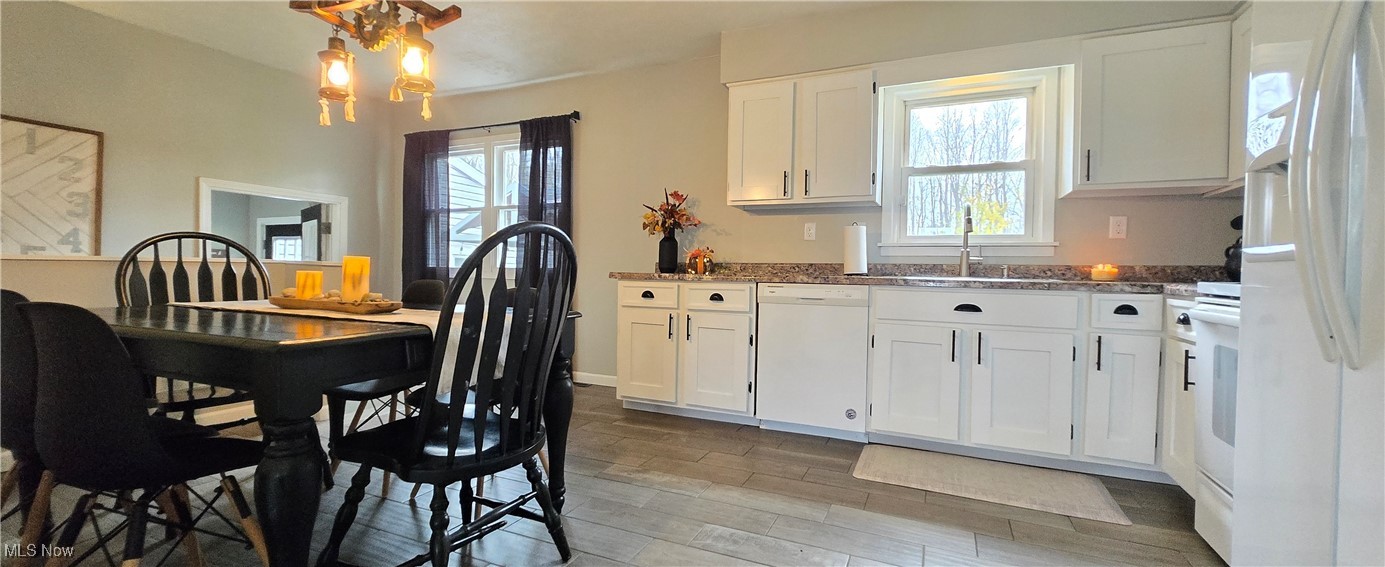591 Seminary Road Norwalk, OH 44857 - Photo 7 of 29 Kitchen featuring white appliances, light hardwood / wood-style floors, white cabinetry, and sink
