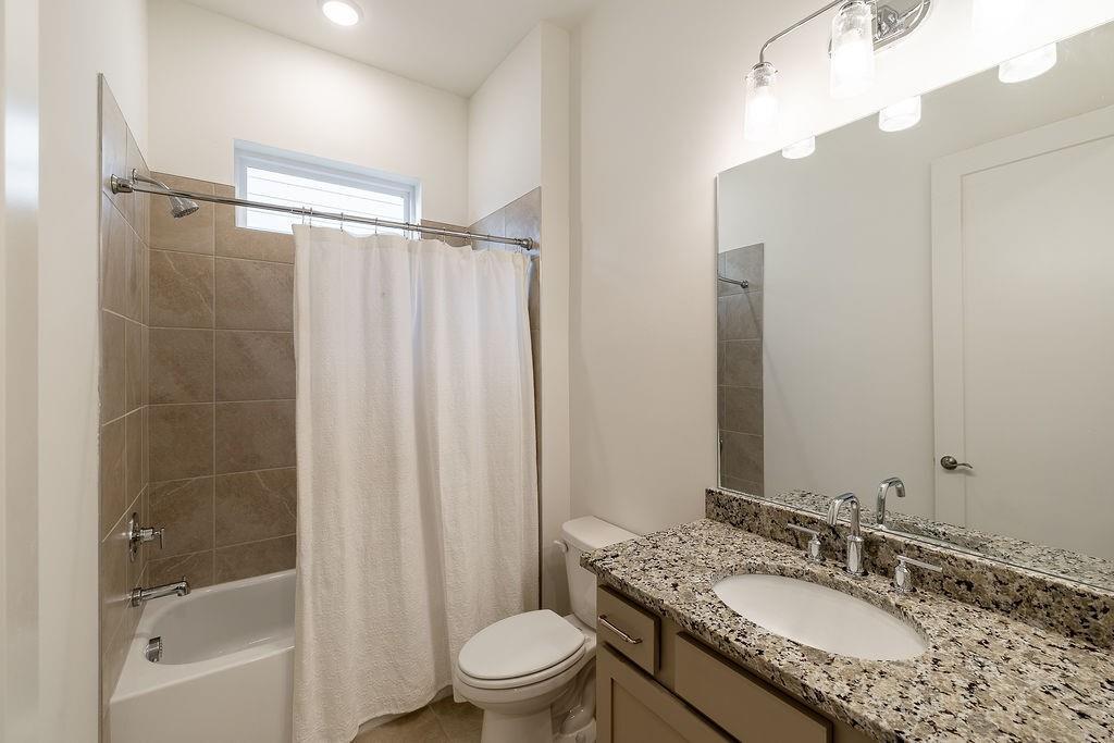 6954 Scenic Overlook Trace Flowery Branch, GA 30542 - Photo 12 of 55 a bathroom with a granite countertop sink toilet and shower