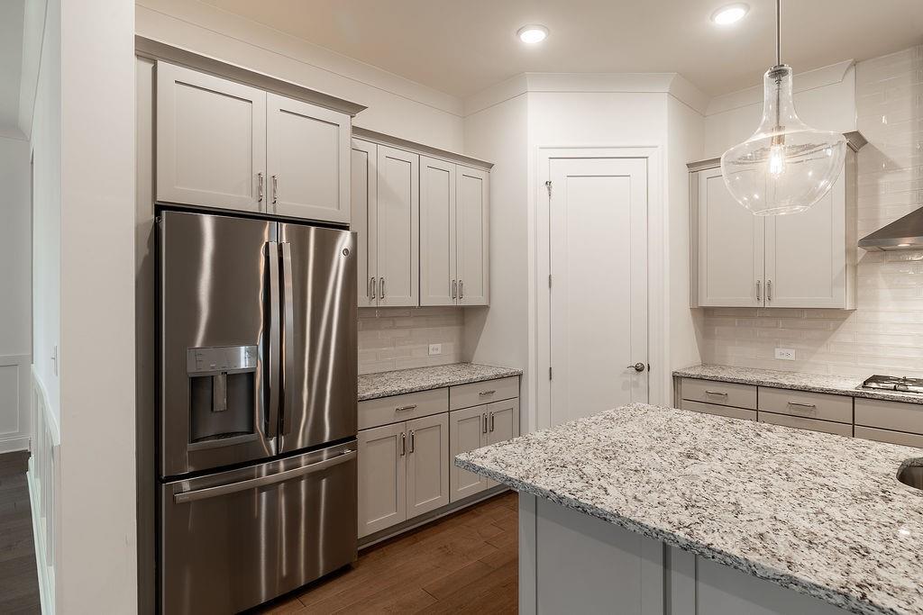 6954 Scenic Overlook Trace Flowery Branch, GA 30542 - Photo 17 of 55 a kitchen with stainless steel appliances granite countertop a refrigerator and a sink