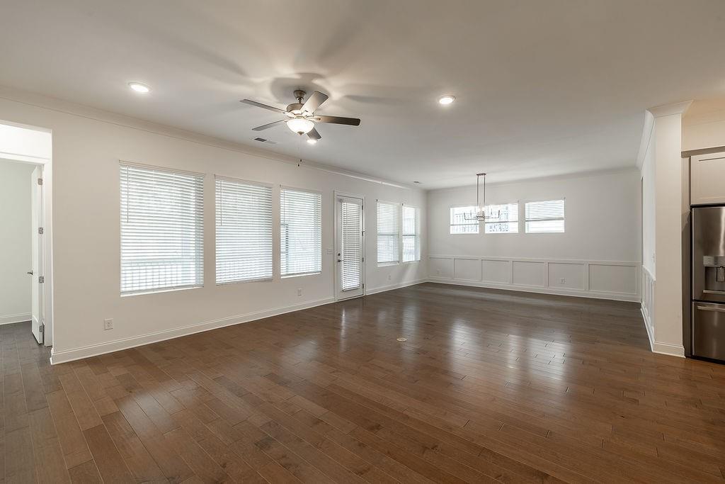 6954 Scenic Overlook Trace Flowery Branch, GA 30542 - Photo 20 of 55 a view of an empty room with wooden floor and a window