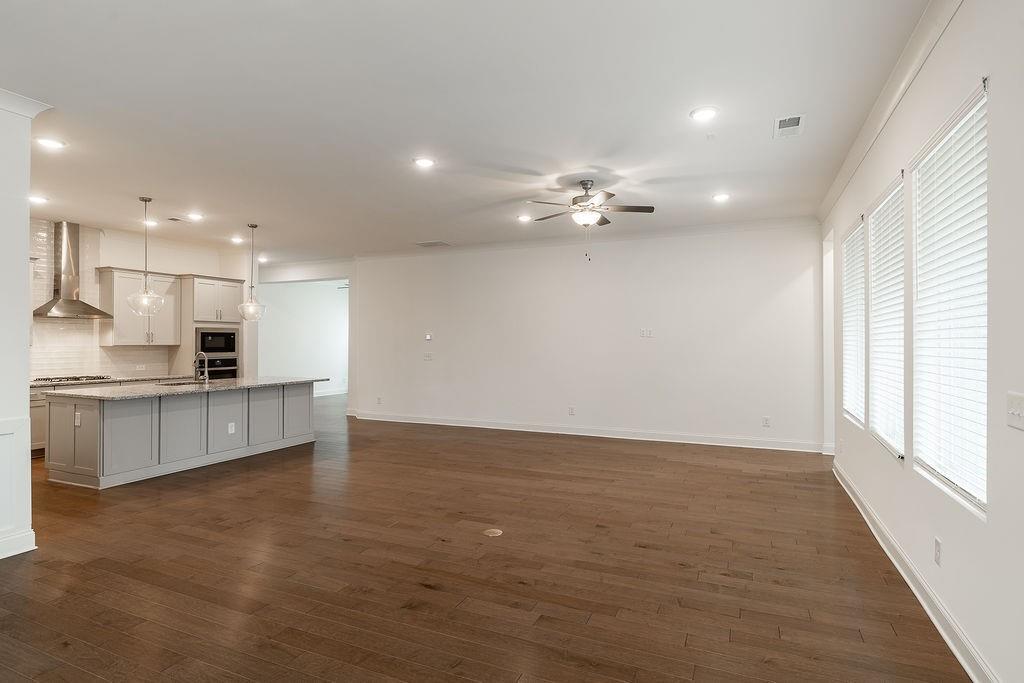 6954 Scenic Overlook Trace Flowery Branch, GA 30542 - Photo 22 of 55 a view of kitchen with kitchen island stainless steel appliances sink large window and cabinets