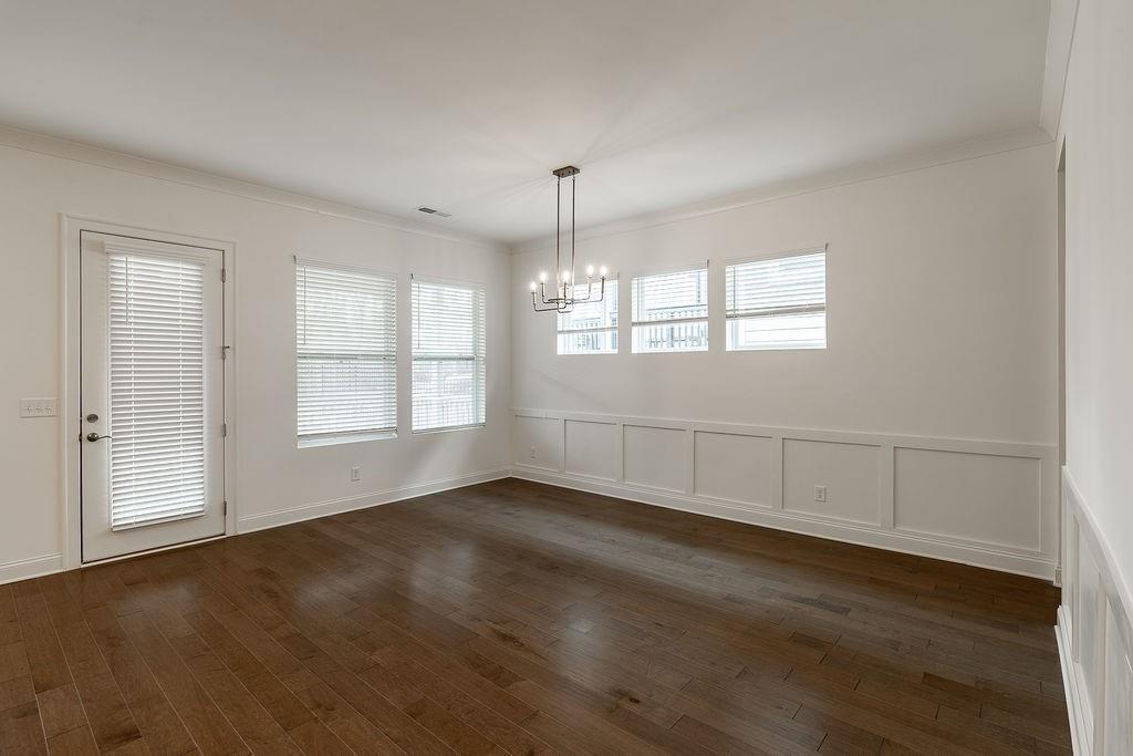 6954 Scenic Overlook Trace Flowery Branch, GA 30542 - Photo 23 of 55 an empty room with wooden floor and windows
