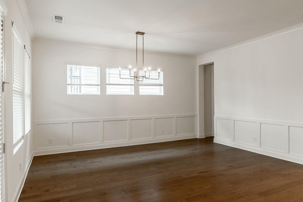 6954 Scenic Overlook Trace Flowery Branch, GA 30542 - Photo 24 of 55 a view of an empty room with wooden floor and a window