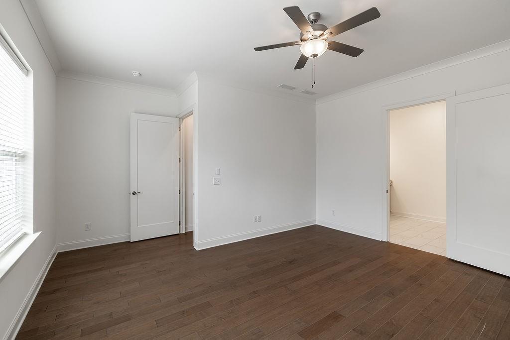 6954 Scenic Overlook Trace Flowery Branch, GA 30542 - Photo 26 of 55 a view of a room with wooden floor and a ceiling fan