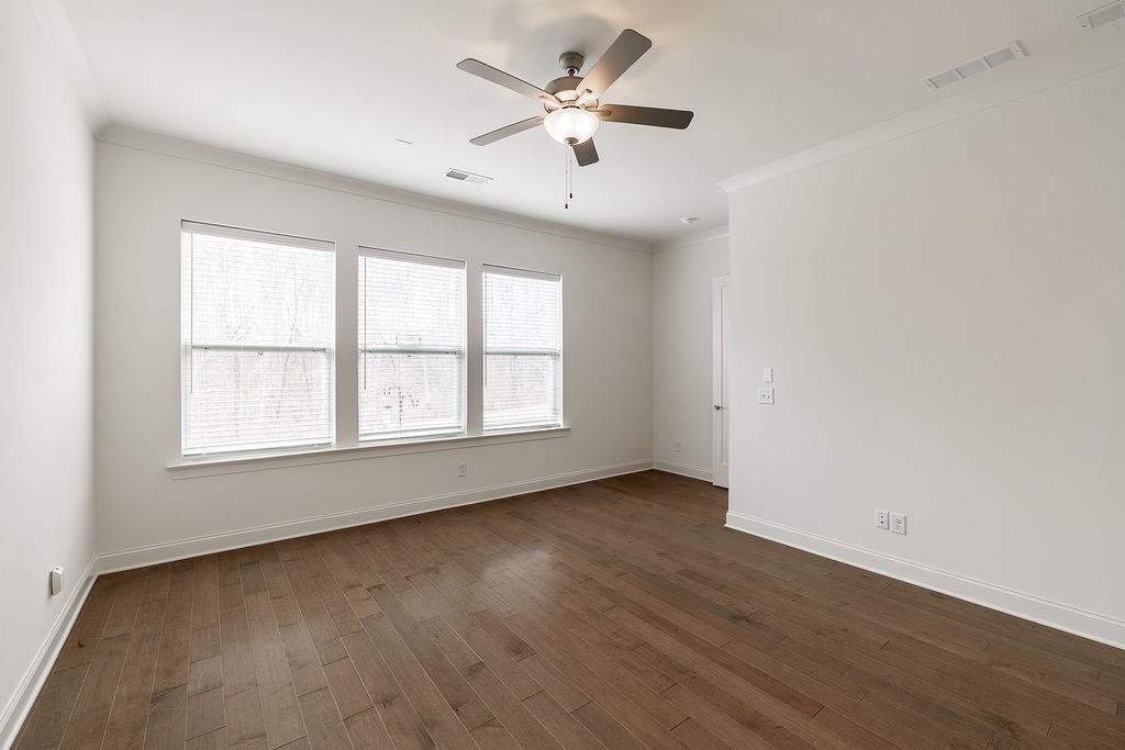 6954 Scenic Overlook Trace Flowery Branch, GA 30542 - Photo 27 of 55 an empty room with wooden floor and windows
