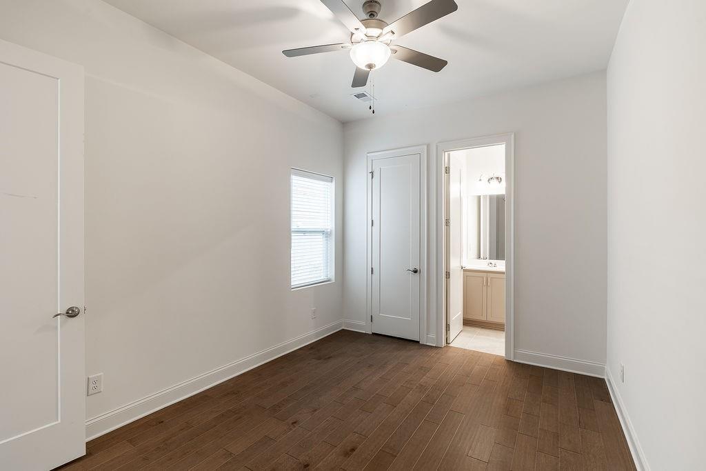 6954 Scenic Overlook Trace Flowery Branch, GA 30542 - Photo 34 of 55 an empty room with wooden floor fan and windows