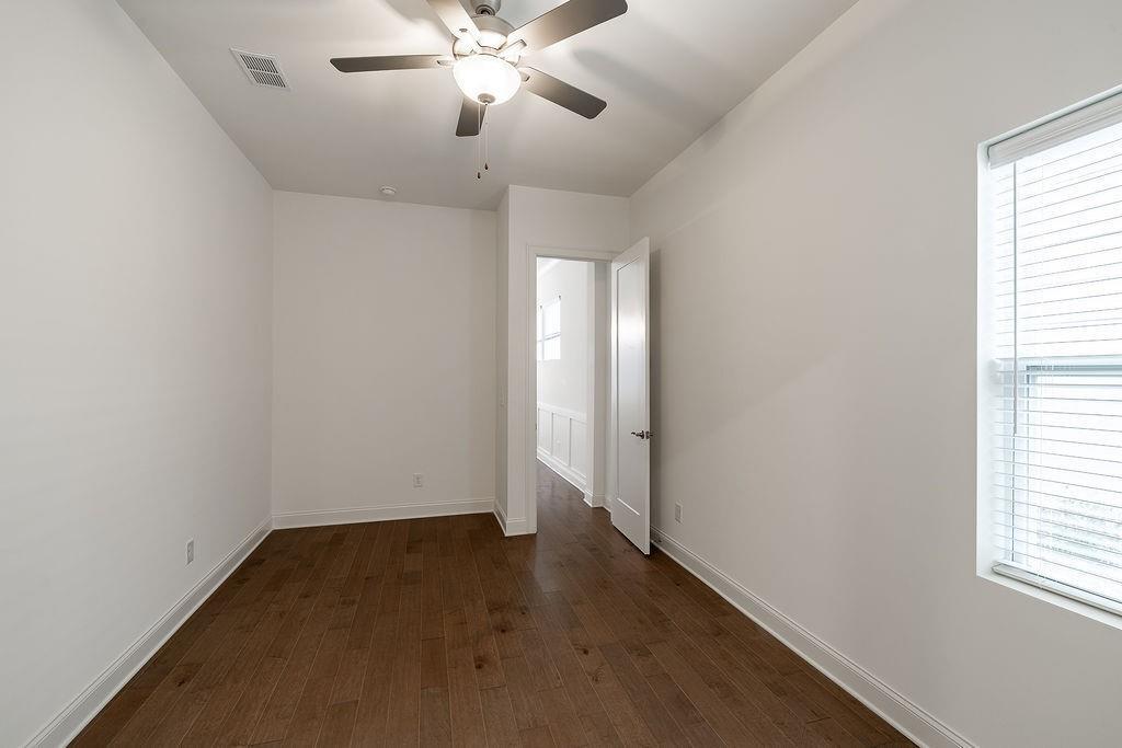 6954 Scenic Overlook Trace Flowery Branch, GA 30542 - Photo 35 of 55 an empty room with windows and fan