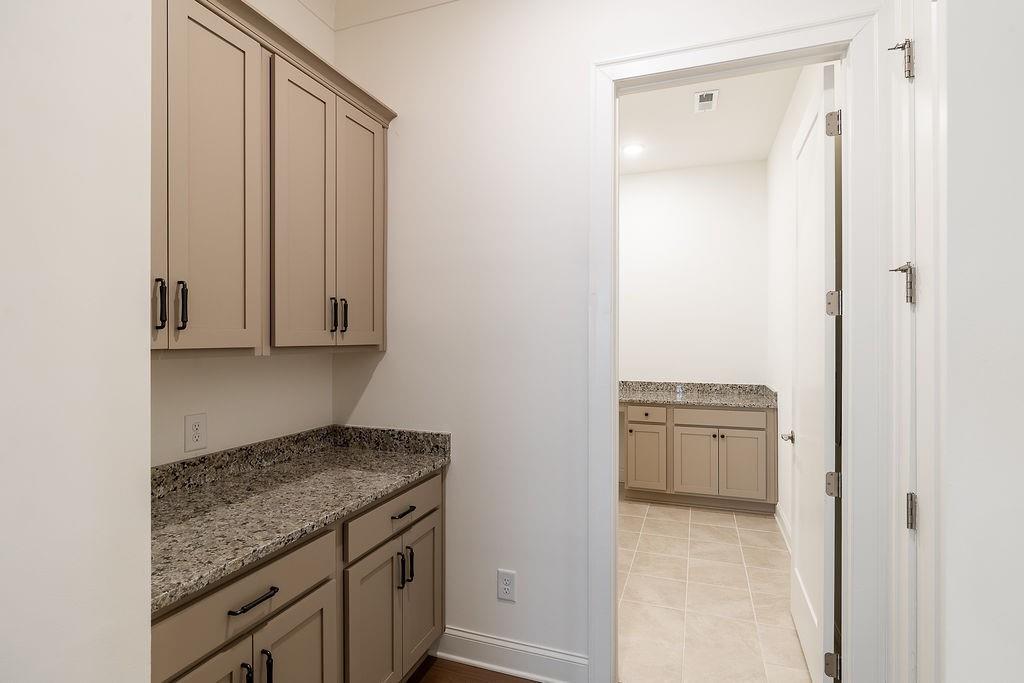 6954 Scenic Overlook Trace Flowery Branch, GA 30542 - Photo 8 of 55 a kitchen with granite countertop cabinets and sink