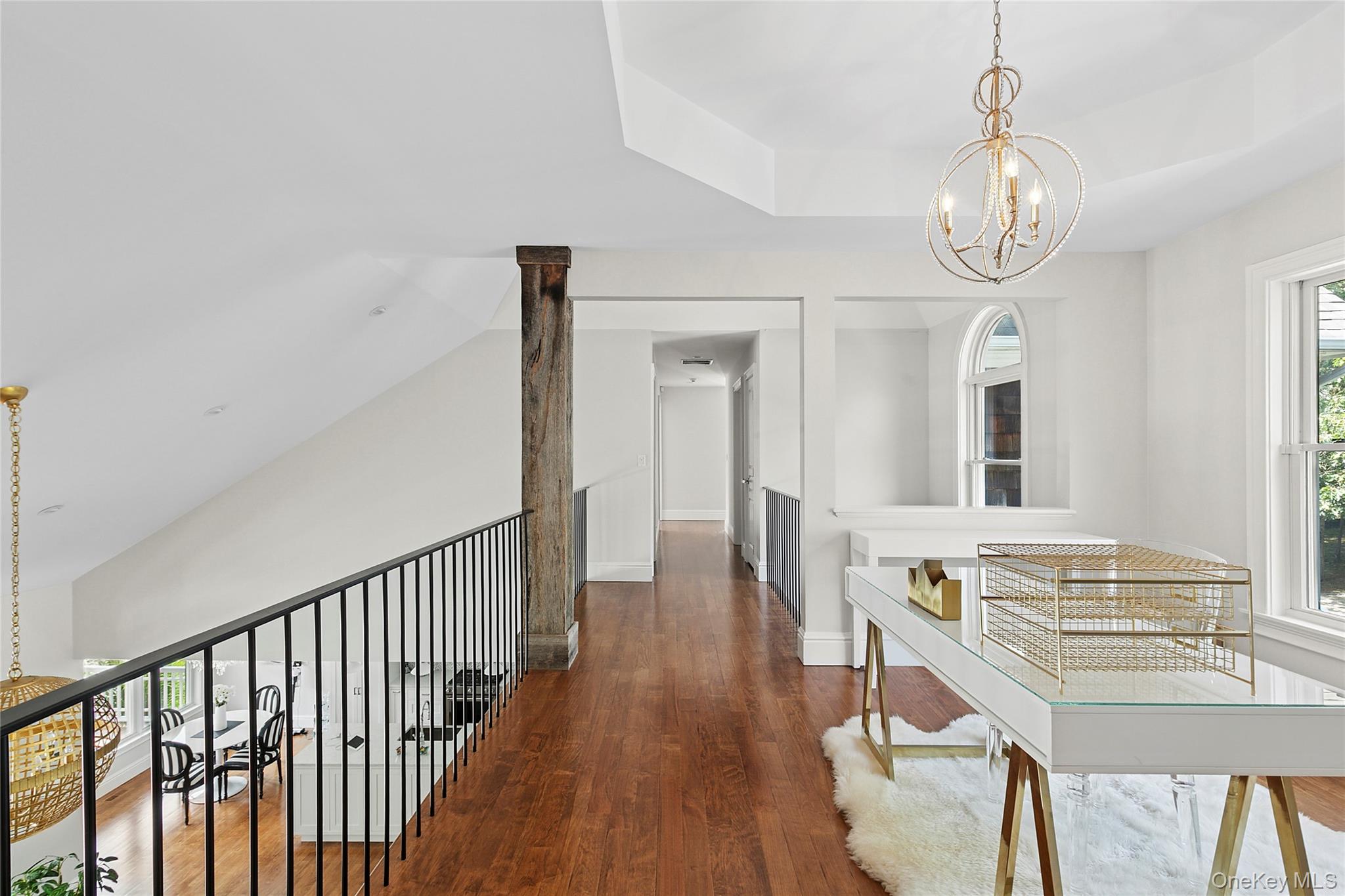 3470 North Bayview Road Southold, NY 11971 - Photo 15 of 25 Loft area used as an office with a chandelier, wood flooring, and a raised ceiling