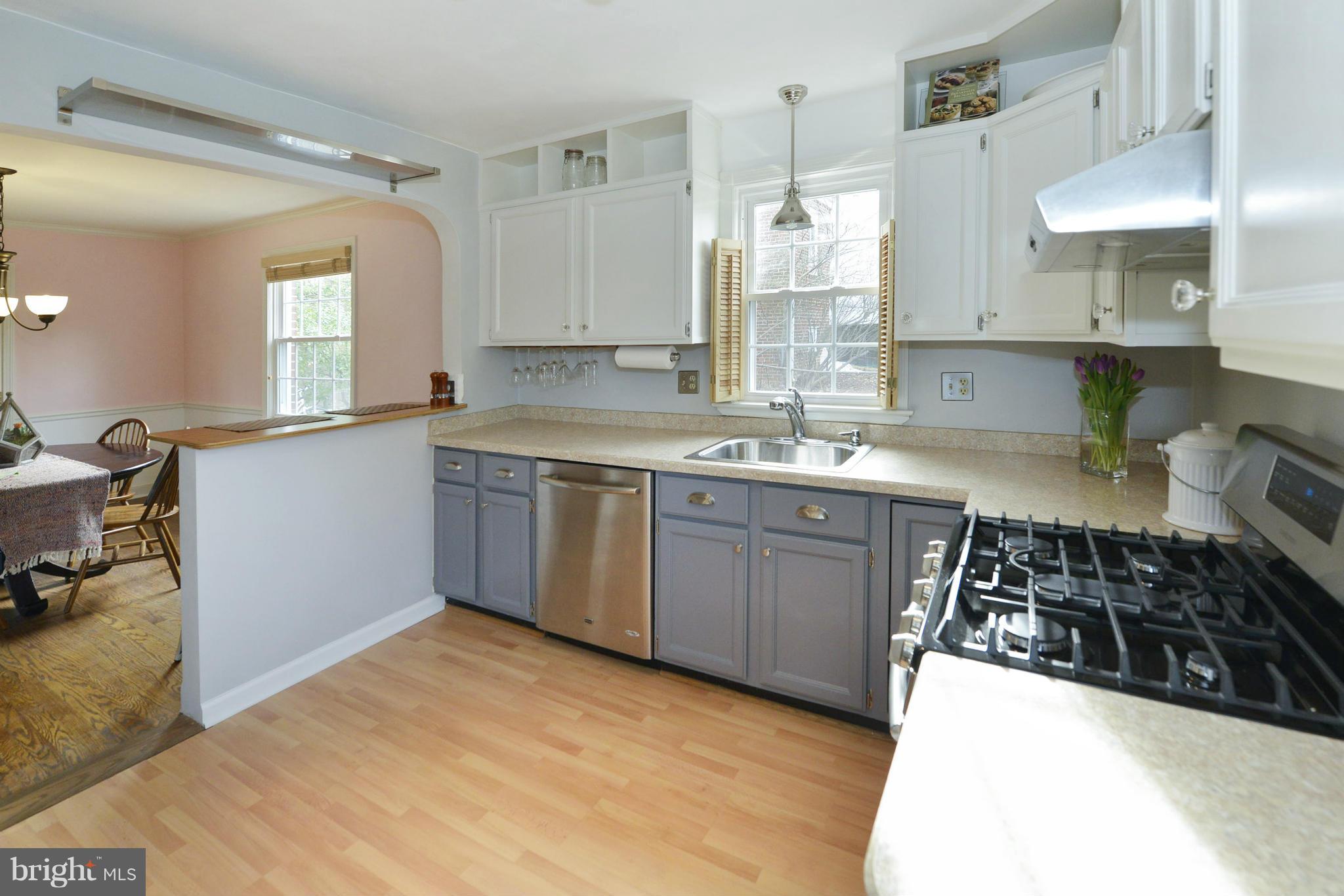 9100 Sudbury Road Silver Spring, MD 20901 - Photo 11 of 30 a kitchen with a sink a stove and cabinets