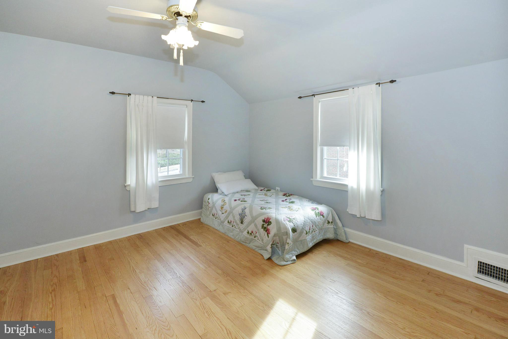 9100 Sudbury Road Silver Spring, MD 20901 - Photo 14 of 30 a bedroom with a bed table and window