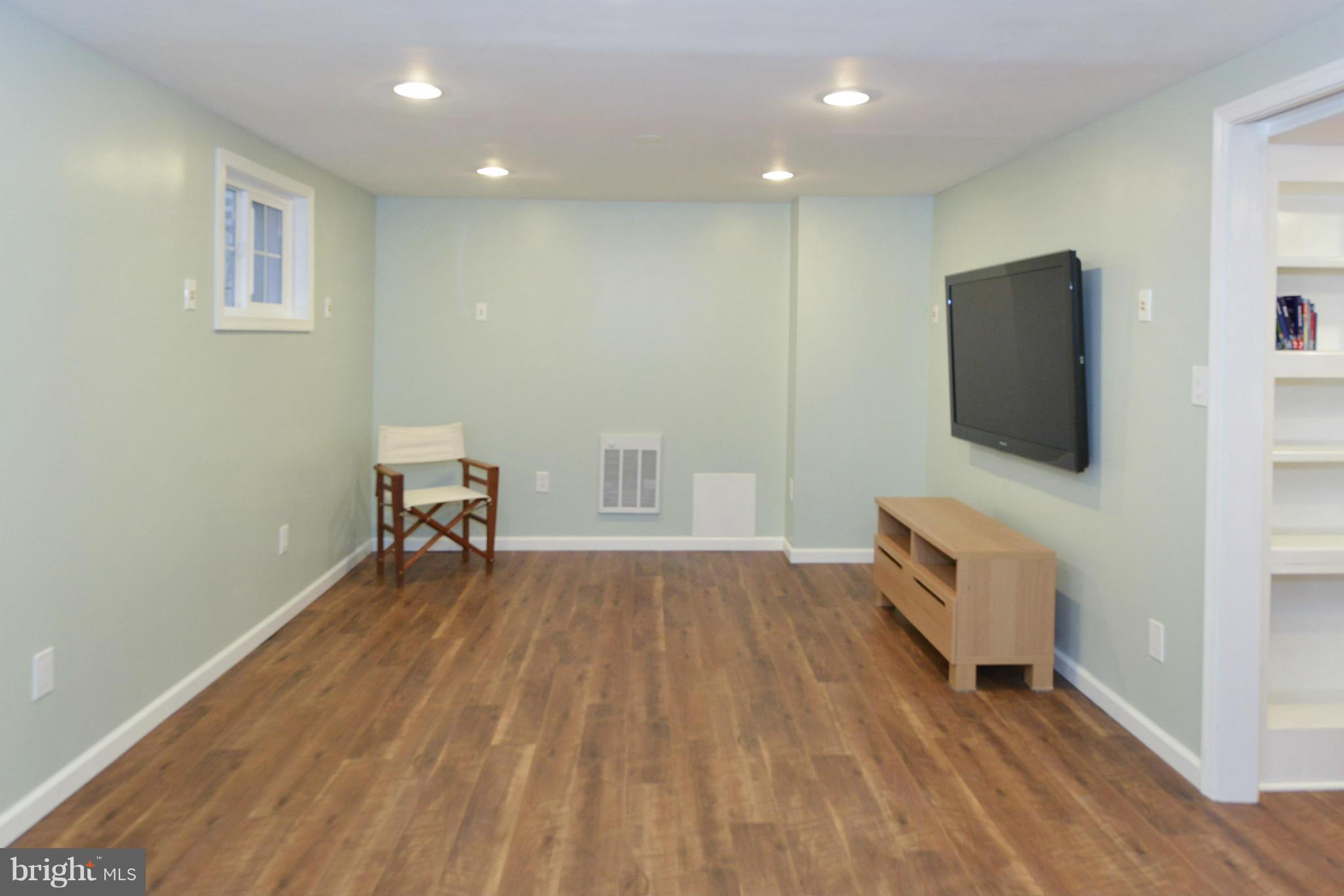 9100 Sudbury Road Silver Spring, MD 20901 - Photo 16 of 30 a view of room with wooden floor and furniture