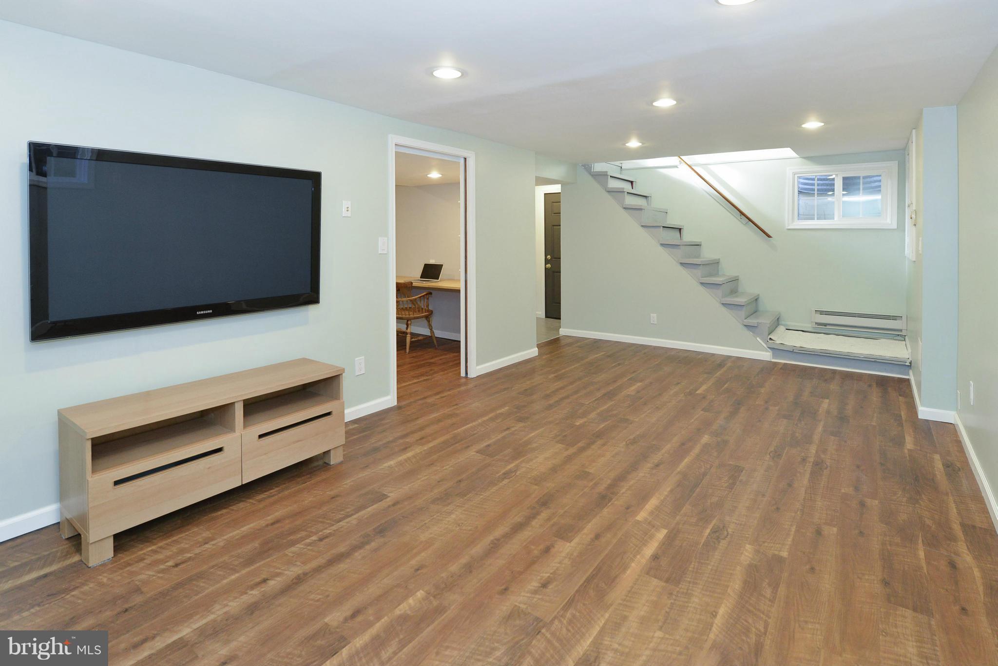 9100 Sudbury Road Silver Spring, MD 20901 - Photo 17 of 30 a view of room with wooden floor and flat screen tv
