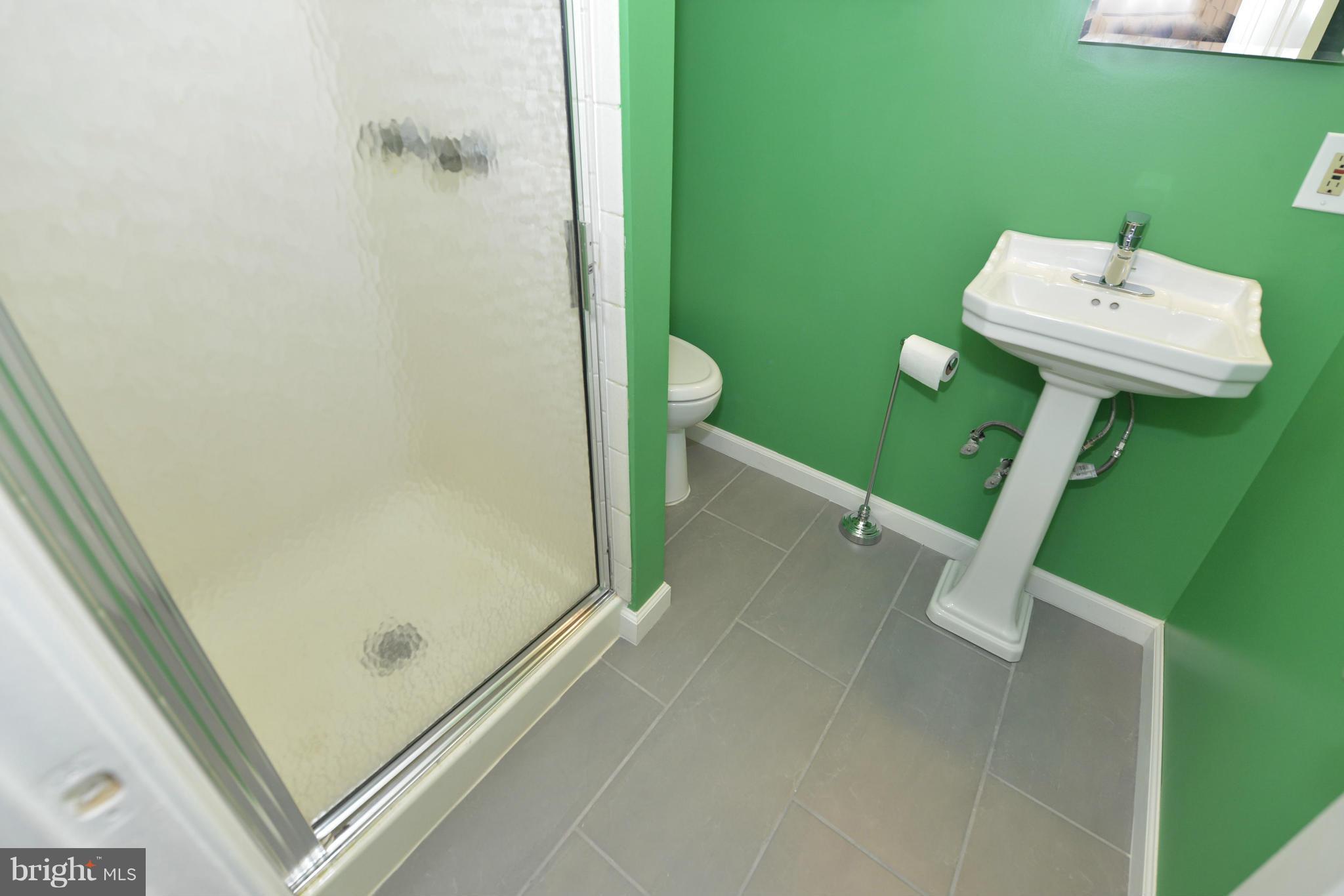 9100 Sudbury Road Silver Spring, MD 20901 - Photo 18 of 30 a bathroom with a sink a toilet and shower
