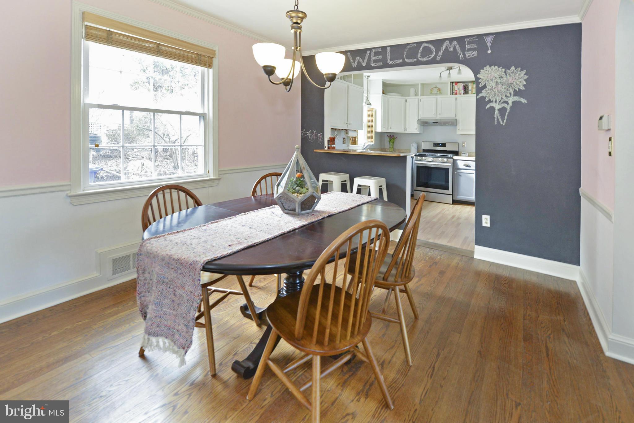 9100 Sudbury Road Silver Spring, MD 20901 - Photo 7 of 30 a view of a dining room with furniture window and wooden floor
