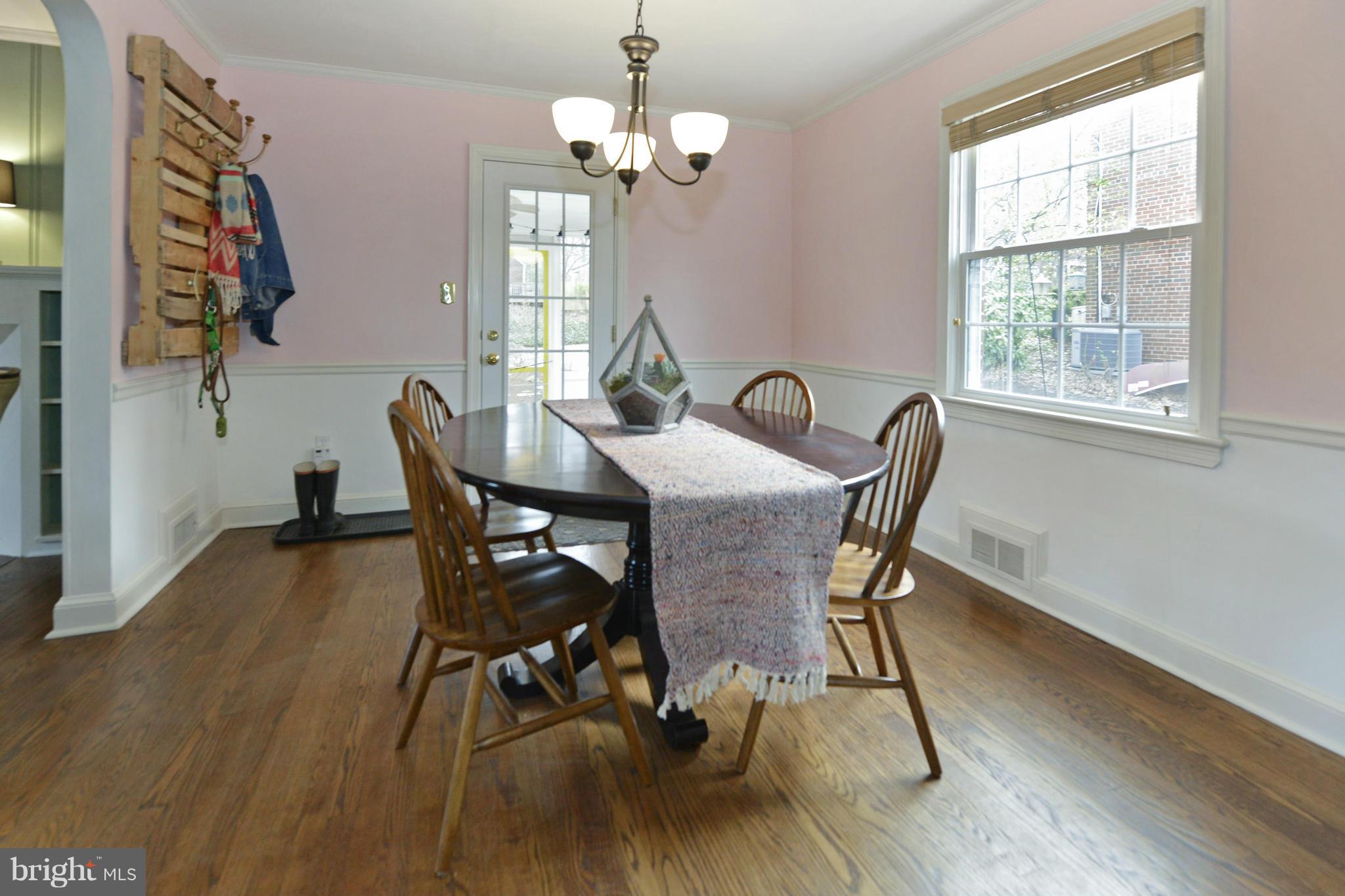 9100 Sudbury Road Silver Spring, MD 20901 - Photo 8 of 30 a view of a dining room with furniture a chandelier and wooden floor