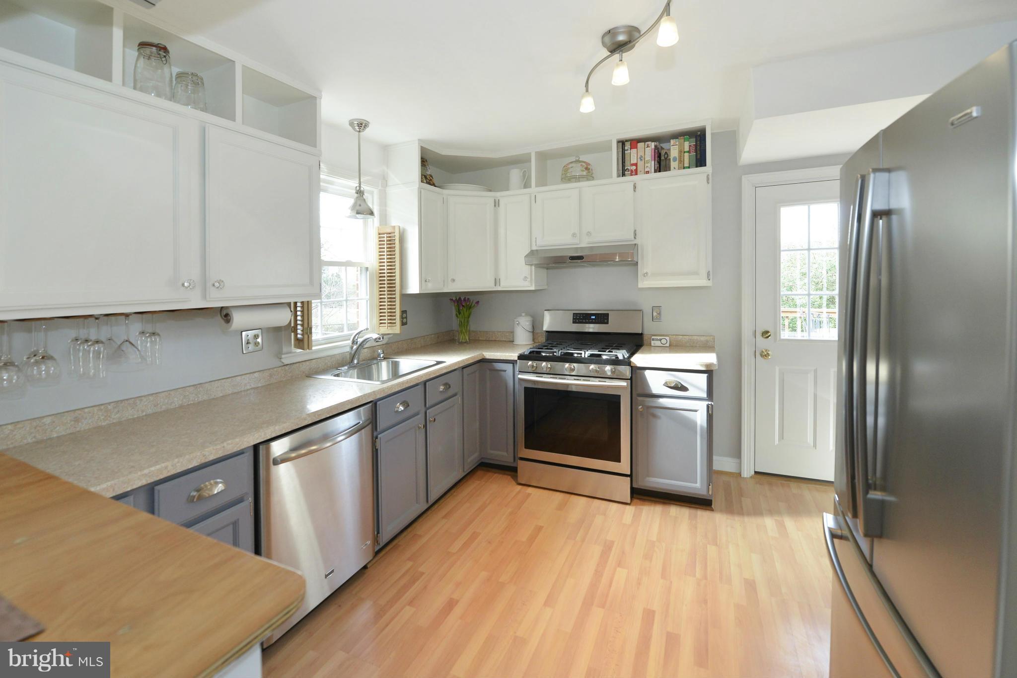 9100 Sudbury Road Silver Spring, MD 20901 - Photo 10 of 30 a kitchen with stainless steel appliances granite countertop a sink stove and refrigerator