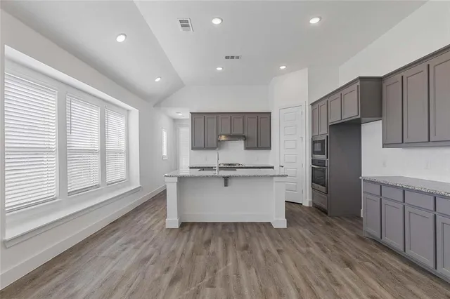 a kitchen with a white cabinets sink and refrigerator