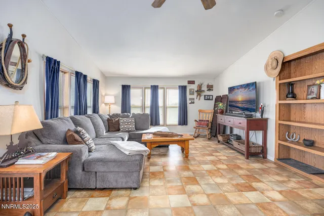 a living room with furniture a flat screen tv and a stove