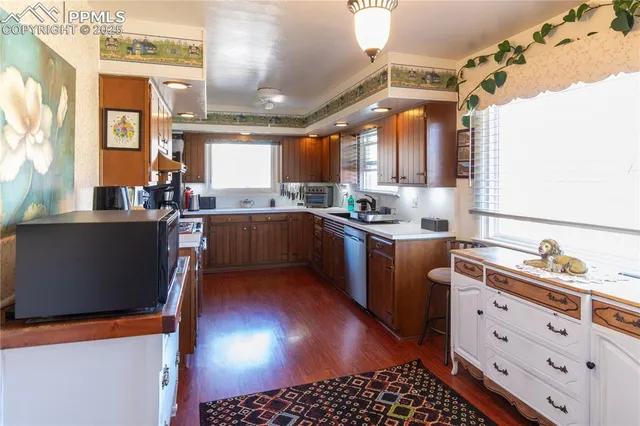 a kitchen with stainless steel appliances kitchen island granite countertop a sink stove and cabinets