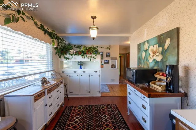 a kitchen with stainless steel appliances a stove a chimney a sink and a microwave