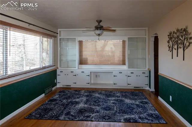 a room with window and a rug