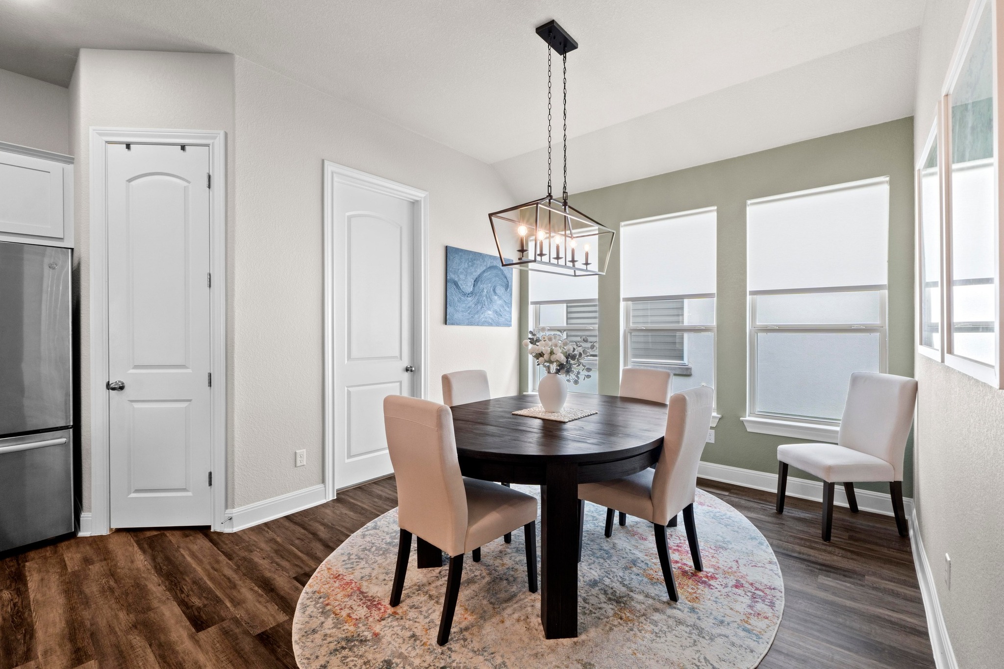 1329 Siena Sunset Road Leander, TX 78641 - Photo 10 of 33 a view of a dining room with furniture window and wooden floor