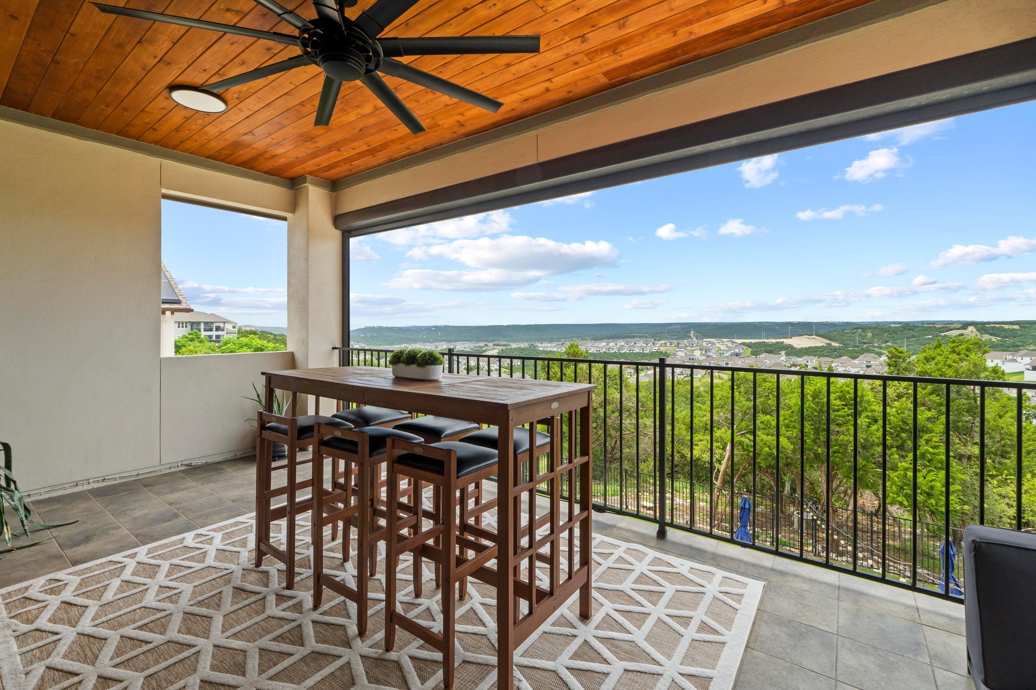 1329 Siena Sunset Road Leander, TX 78641 - Photo 22 of 33 a view of a balcony with furniture and a floor to ceiling window