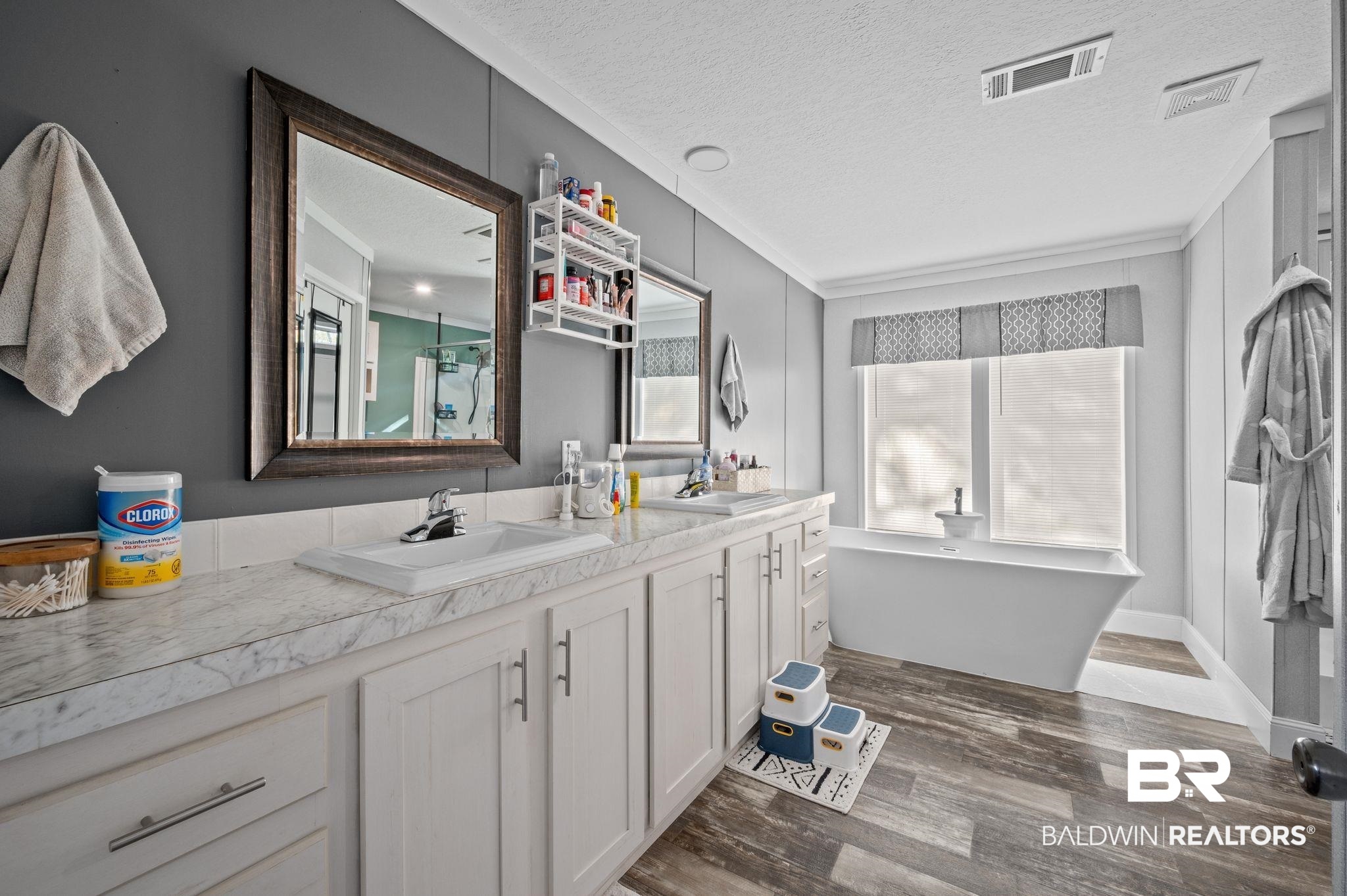 9382 D'Olive Street Bay Minette, AL 36507 - Photo 9 of 27 Bathroom with a washtub, a textured ceiling, hardwood / wood-style flooring, and a healthy amount of sunlight