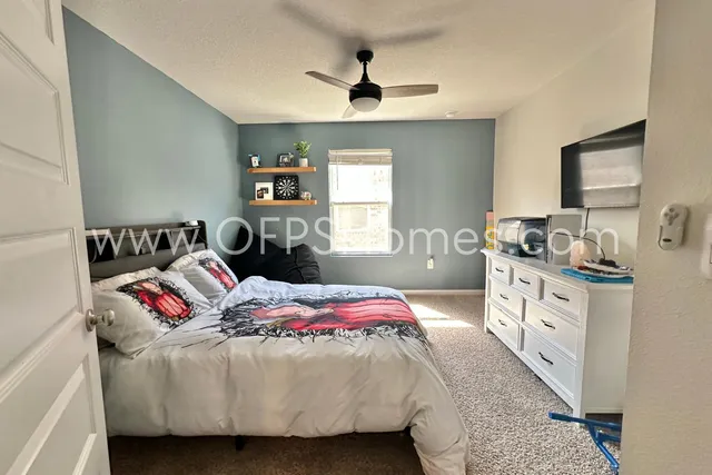 a bedroom with a bed and a chandelier