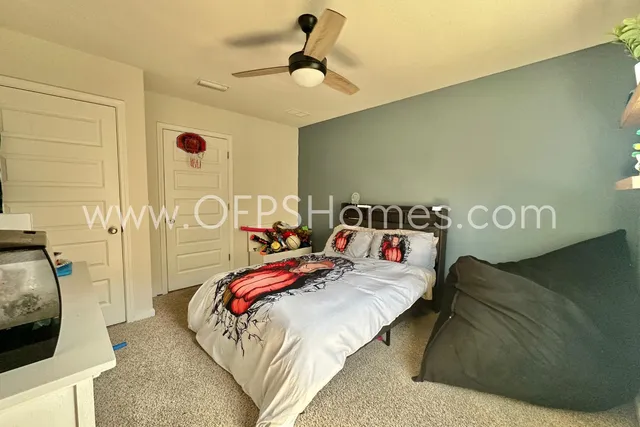 a bedroom with a bed and a chandelier