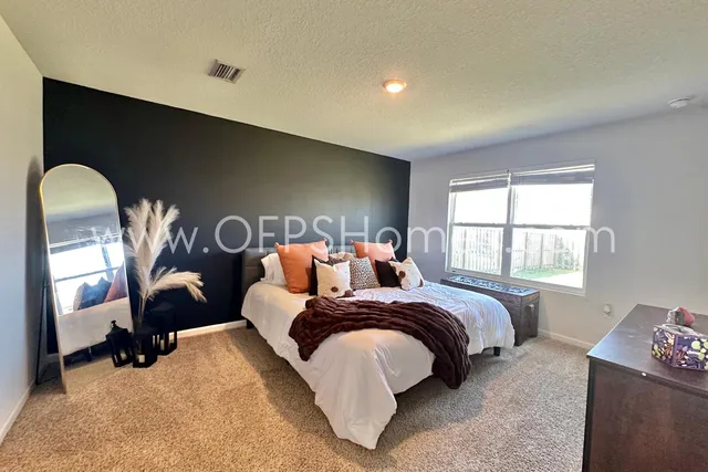 a bed room with a bed and a chair