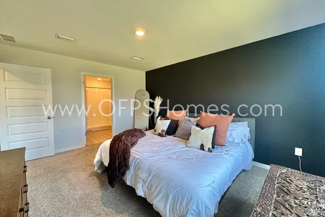 a bedroom with bed and a night stand