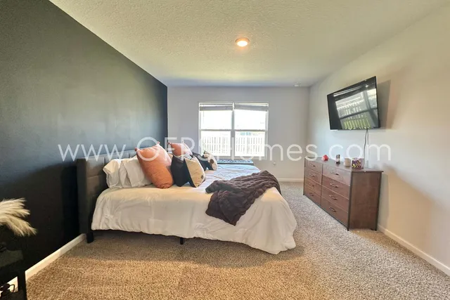 a bedroom with a bed and a couch