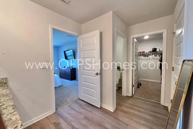 a view of a hallway view with wooden floor and dining room