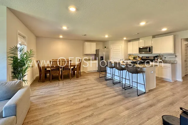 a kitchen with lots of counter top space and furniture