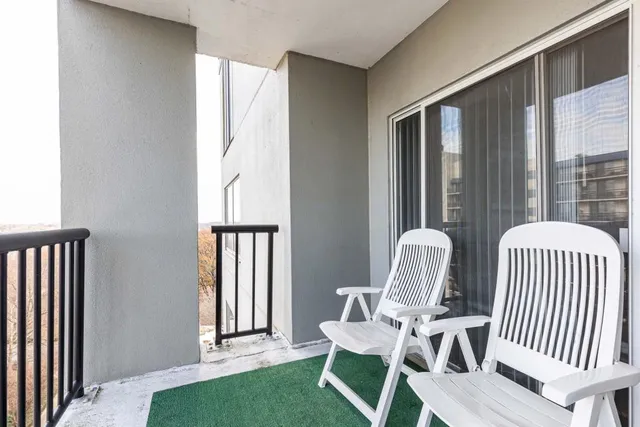 a view of a balcony with chair and table