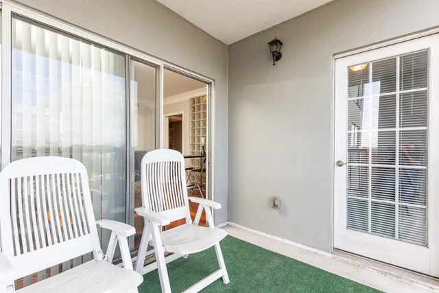 a balcony with table and chairs