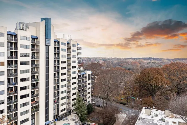 a living room with furniture a chandelier and a dining table