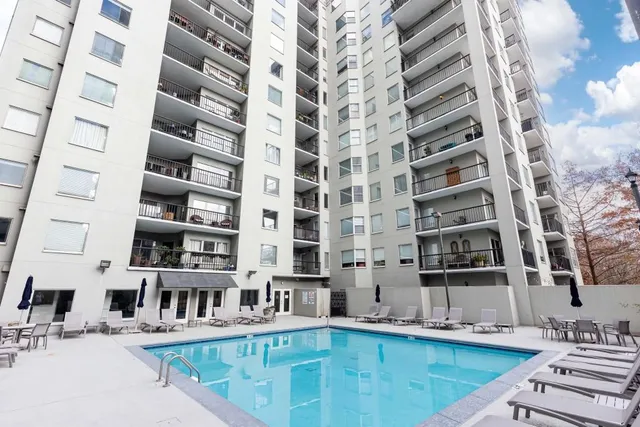 a view of a dinning tables and chairs in the patio in front of a building