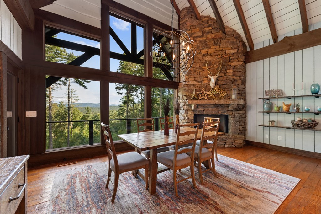 114 Price Circle Blue Ridge, GA 30513 - Photo 11 of 65 a dining room with furniture a fireplace and wooden floor