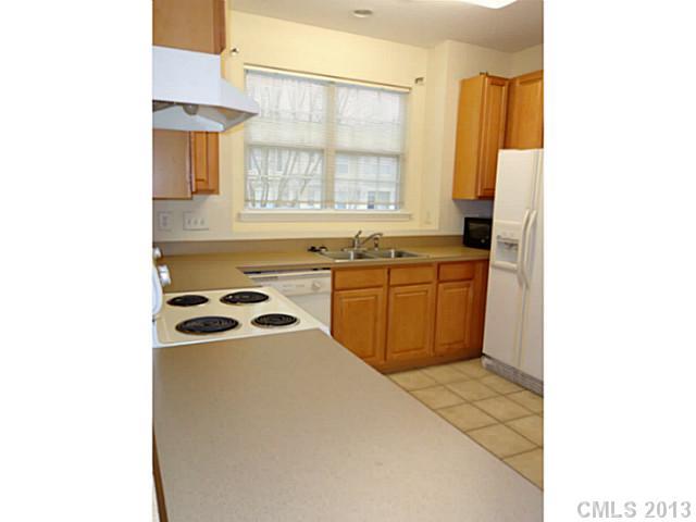 904 Copperstone Lane, Unit 182 Fort Mill, SC 29708 - Photo 6 of 14 a kitchen with a sink a stove and cabinets