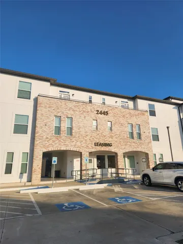 a view of a big building next to a big yard