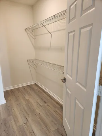 a view of a room with wooden floor and cabinet