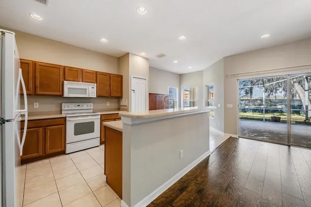 a kitchen with stainless steel appliances a refrigerator and a stove top oven