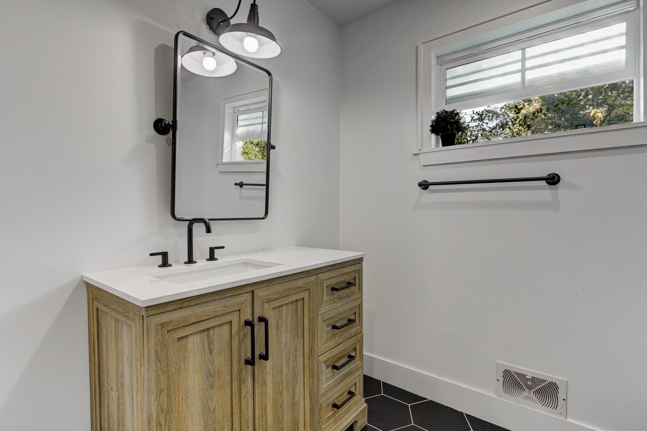 3914 Springfield Drive Memphis, TN 38128 - Photo 20 of 33 a bathroom with a sink a light fixture and a mirror