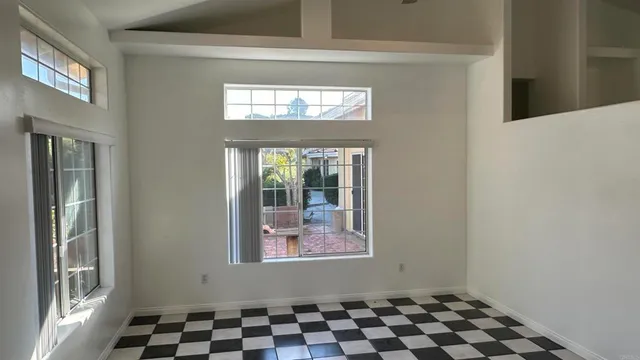 a view of a livingroom with wooden floor and a window