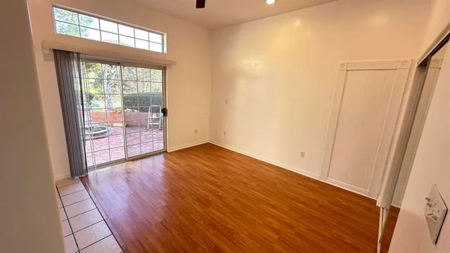 a bathroom with a granite countertop sink a mirror and a bathtub