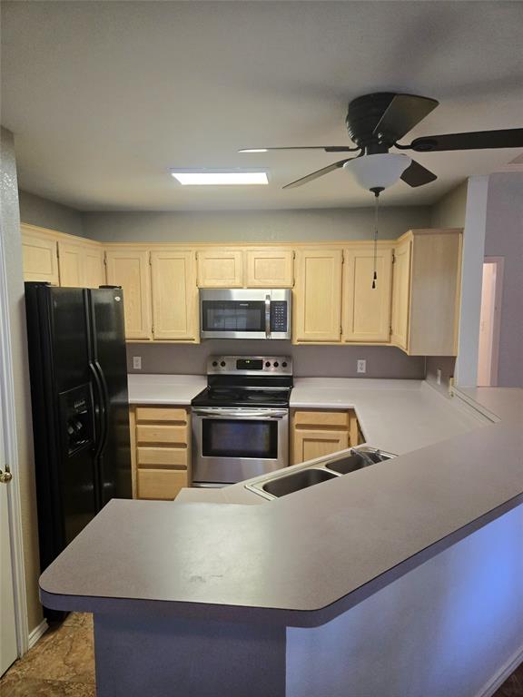 604 Valleyridge Court Decatur, TX 76234 - Photo 6 of 35 a kitchen with stainless steel appliances a refrigerator and a stove top oven