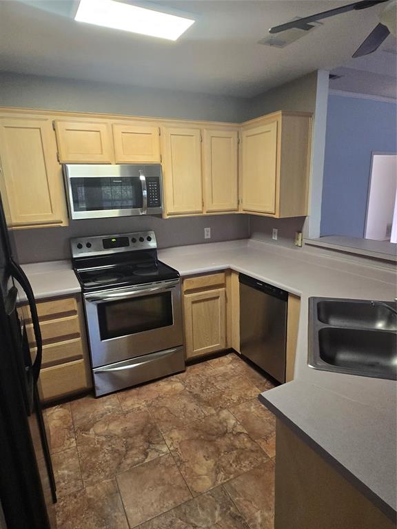 604 Valleyridge Court Decatur, TX 76234 - Photo 8 of 35 a kitchen with a stove a sink and a microwave